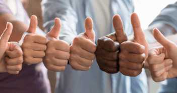 A group displaying thumbs up