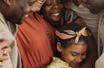 Intergenerational Ministry for the Post-pandemic Church Group of people of different ages smiling and embracing at church