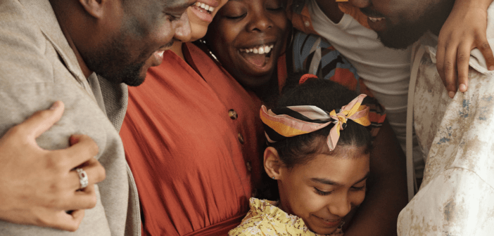 Group of people of different ages smiling and embracing at church