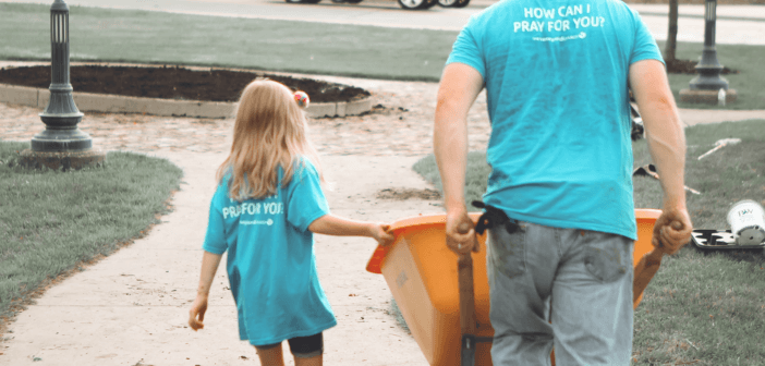 Child and adult volunteering together at a church service project