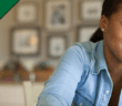 Smiling person looking at laptop