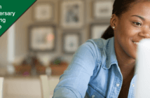 Smiling person looking at laptop