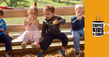 Kids outside on a bench having snacks