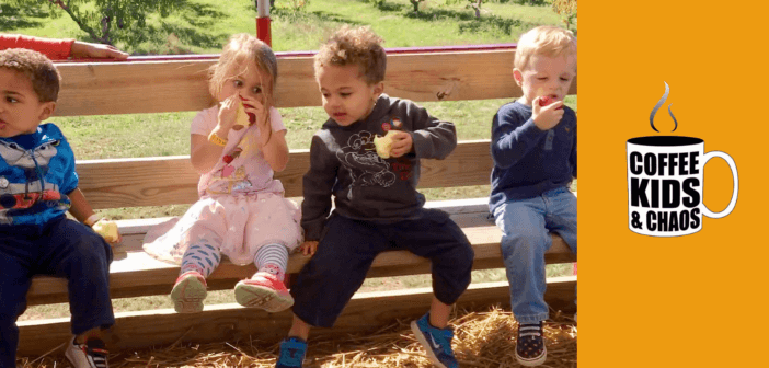 Kids outside on a bench having snacks