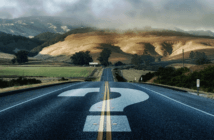 Moving Forward in Uncertain Times Question mark painted on a road that disappears into the horizon