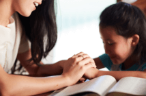 4 Approaches to Keeping Small Church Worship and Education Vibrant During the Pandemic Parent and child at the dining table reading the Bible and praying together