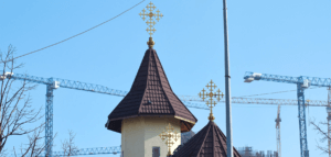 Church steeple and construction cranes
