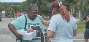 Person praying with another person in a parking lot