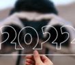 Person looking through binoculars at the number 2022