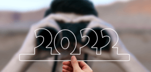 Person looking through binoculars at the number 2022