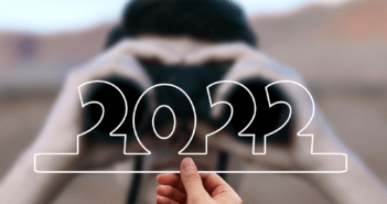 Person looking through binoculars at the number 2022