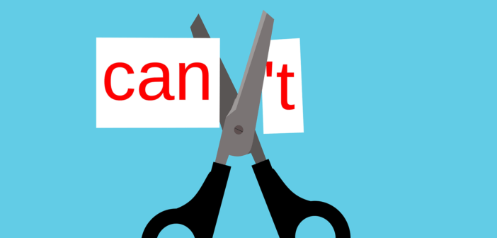 Scissors cutting the apostrophe T off of the word CANT