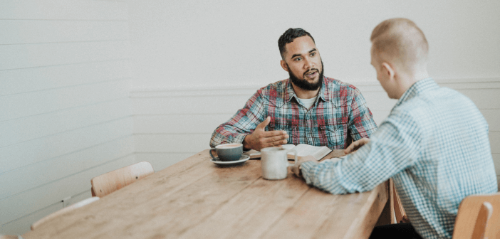 Two people having a conversation at a coffee shop