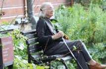 Elderly woman sitting on a park bench