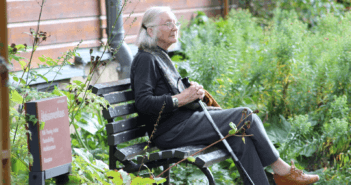 Elderly woman sitting on a park bench