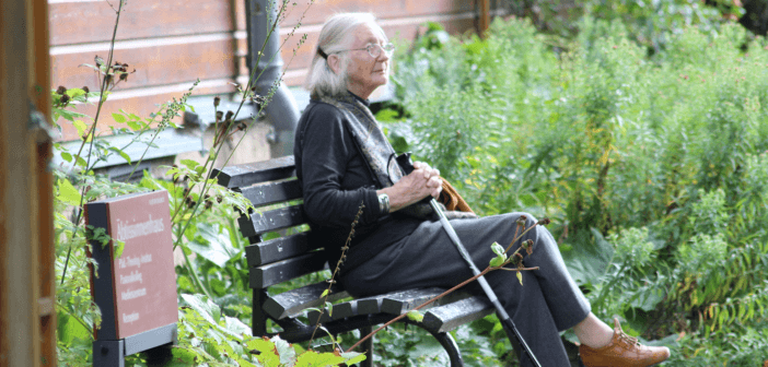 Elderly woman sitting on a park bench