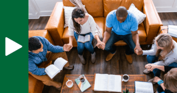 People praying in the living room of a house church worship service