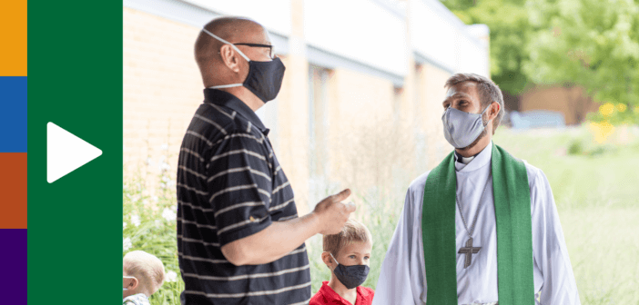 Masked pastor and church member chatting outside after church