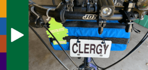 Metal tag that says PASTOR hanging on the front handlebars of a bicycle