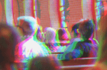 Distorted and out-of-focus image of a congregation sitting in pews