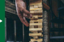 Person carefully removing blocks from a Jenga tower