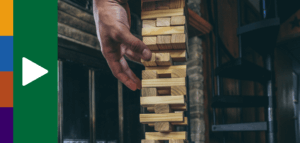 Person carefully removing blocks from a Jenga tower