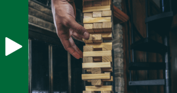 Person carefully removing blocks from a Jenga tower