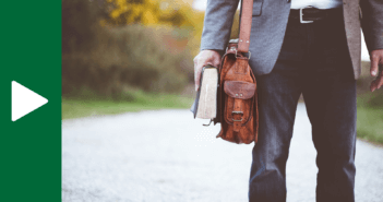 Person carrying both a messenger back for work and a Bible