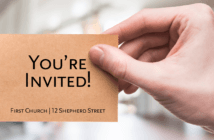 Hand holding a card that reads YOU'RE INVITED!