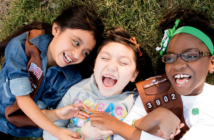 Diverse trio of smiling Girl Scouts