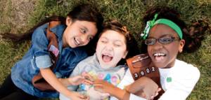 Diverse trio of smiling Girl Scouts