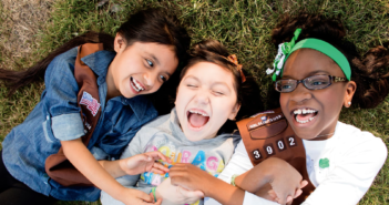 Diverse trio of smiling Girl Scouts