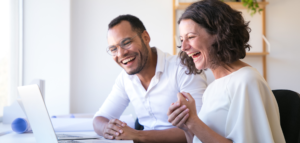 Smiling couple viewing an online worship service