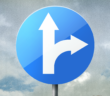 Road sign showing one my go straight forward or turn toward the right