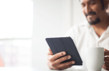 Smiling person viewing a playlist on a tablet
