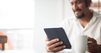 Smiling person viewing a playlist on a tablet