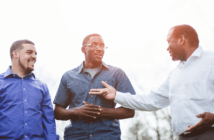 Pastor having a conversation with two young adults