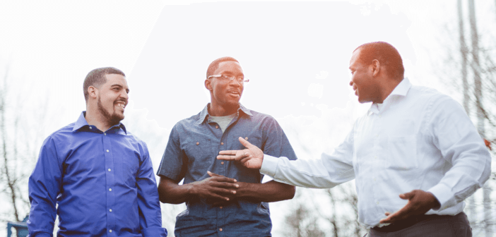 Pastor having a conversation with two young adults