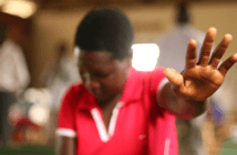 Person worshipping in a small-congregation church
