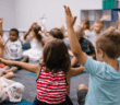 Children in a Sunday school classroom engaging with their teacher and each other
