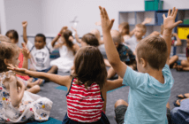 Children in a Sunday school classroom engaging with their teacher and each other