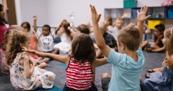 Children in a Sunday school classroom engaging with their teacher and each other