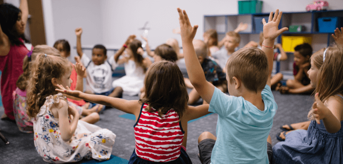 Children in a Sunday school classroom engaging with their teacher and each other