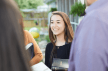 Standing outside chatting with people in the church's community