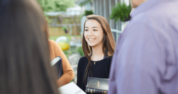 Standing outside chatting with people in the church's community