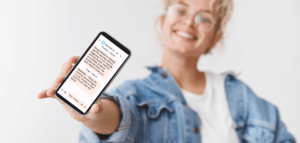 Smiling person holding a cell phone