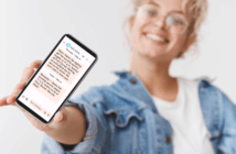 Smiling person holding up a cellphone