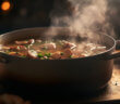 Big pot of soup simmering on a stove