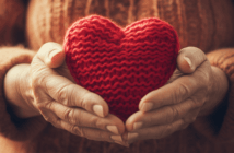 Hands holding a crocheted heart