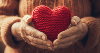 Hands holding a crocheted heart